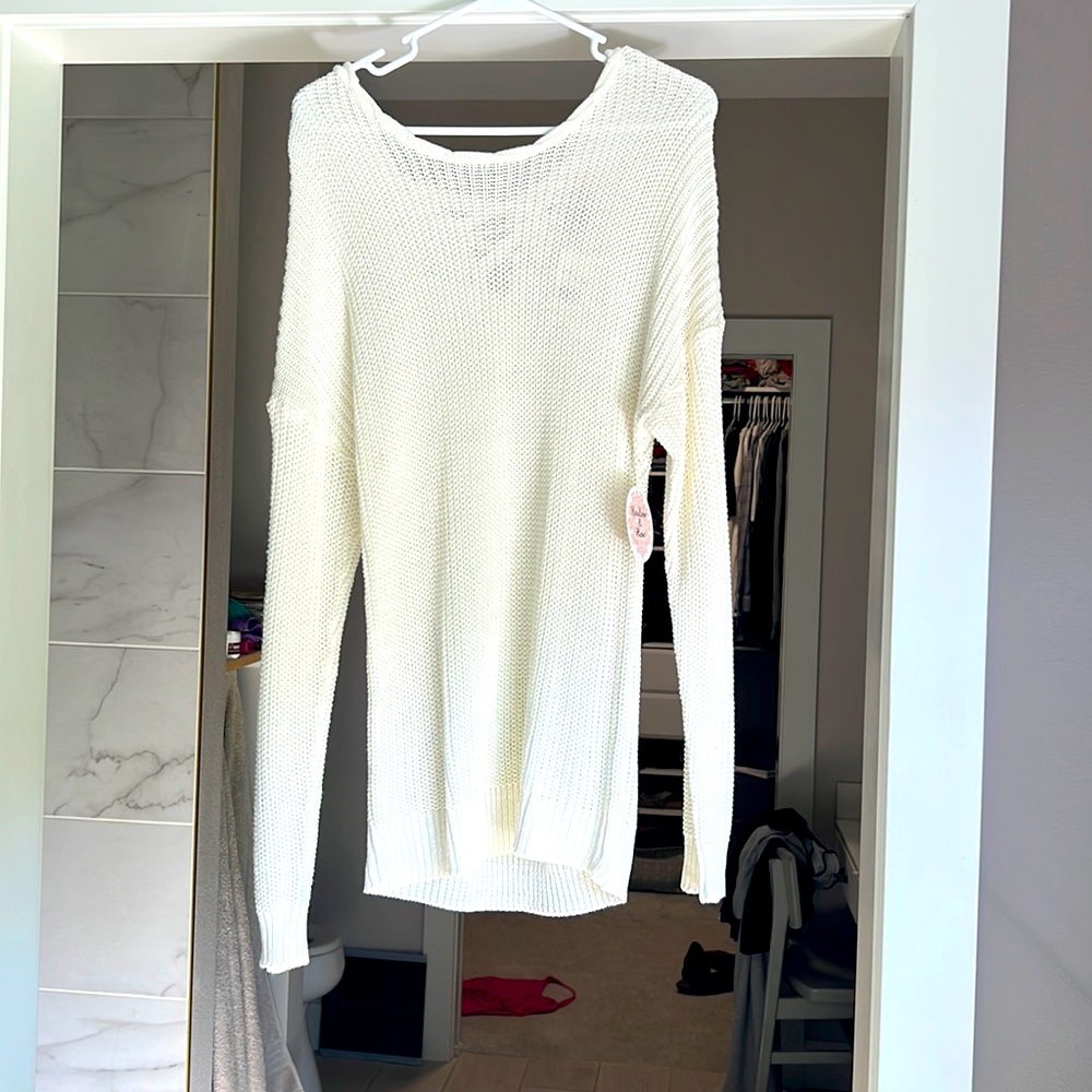 White cable knit sweater with back tie down detail